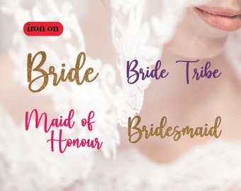 May include: Iron-on patches with gold glitter text that reads "Bride", "Bride Tribe", "Maid of Honour", and "Bridesmaid".