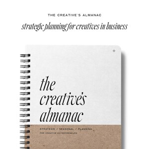 May include: A white spiral bound notebook with the text "the creative's almanac" in black cursive font. The notebook has a brown paper cover with the text "STRATEGIC / SEASONAL / PLANNING FOR CREATIVE ENTREPRENEURS" in black text.