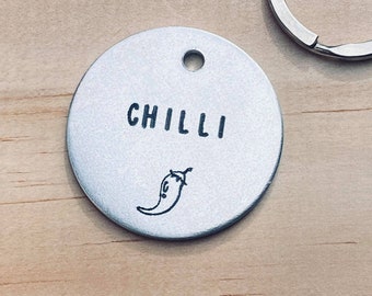 May include: A silver round tag with the word "CHILLI" and a small black chilli pepper illustration.