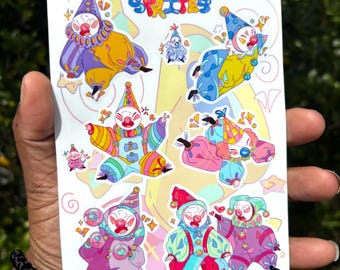 May include: A white sticker sheet featuring colorful cartoon clown sprites. The clowns are in various poses and outfits, with a variety of colors including yellow, blue, pink, and purple. The text "Giggle Sprites" is at the top of the sheet.