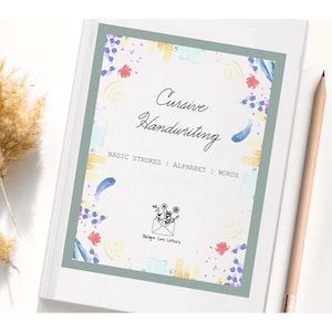 May include: A white workbook titled Cursive Handwriting with the subtitle BASIC STROKES | ALPHABET | WORDS. The cover features a sage green border and colorful watercolor accents. A small black line drawing of an envelope with flowers is centered.