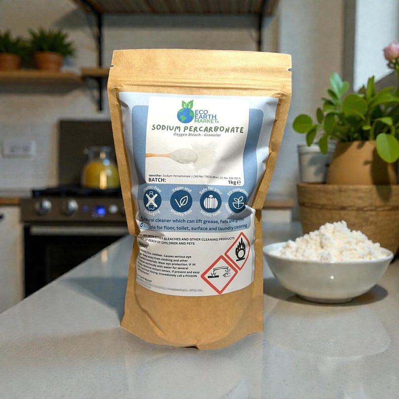 May include: A brown paper bag of Eco Earth Planet Sodium Percarbonate, a natural cleaner. The bag has a blue and white label with product information and safety symbols. A white bowl of the granular product sits nearby.