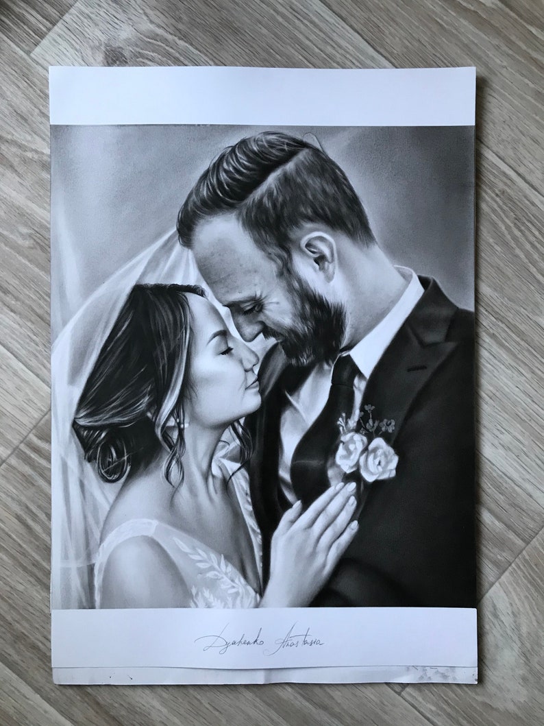 May include: A black and white drawing of a bride and groom embracing. The bride is wearing a white dress and veil, and the groom is wearing a black suit. The drawing is signed "Dylando Thomas".