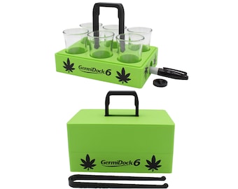 May include: A bright green carrying case with a black handle and the text "GermiDock 6". The case holds a tray with six clear shot glasses. A black marker and accessories are included. The tray has cannabis leaf designs.