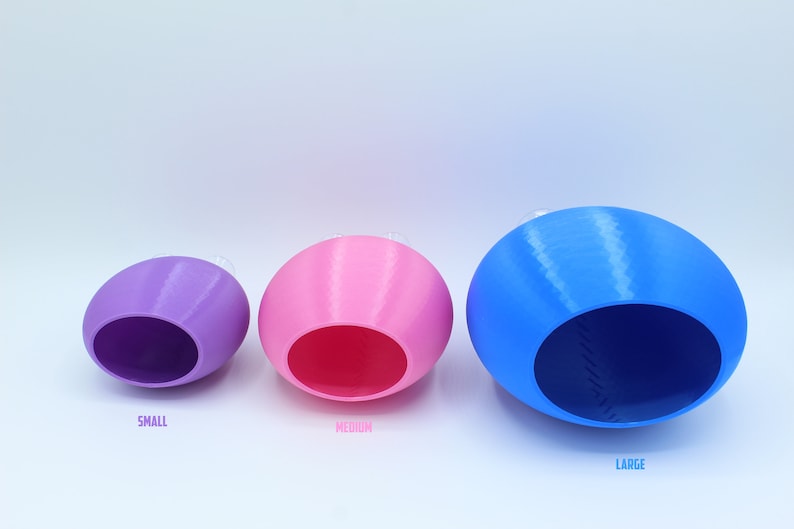 May include: Three ceramic nesting bowls in different sizes. The smallest bowl is purple, the middle bowl is pink, and the largest bowl is blue.
