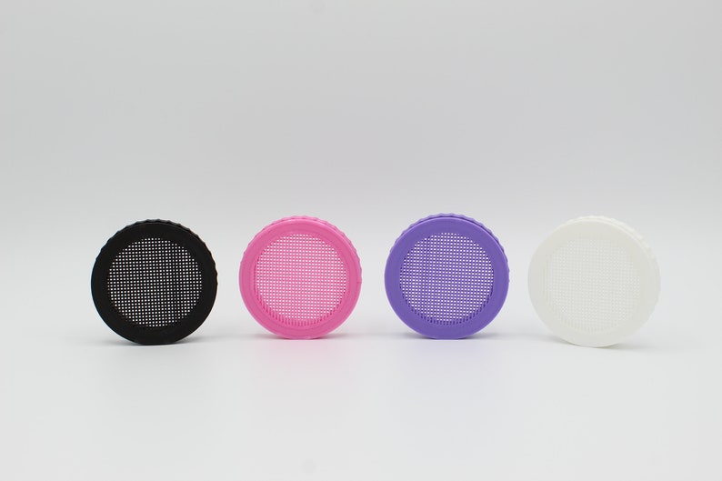 May include: Four round plastic lids with a mesh screen in the center. The lids are black, pink, purple, and white.