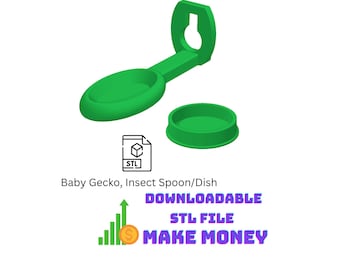May include: A green plastic baby gecko insect spoon and dish set. The spoon features a long handle with a keyhole-shaped mounting bracket at one end and an oval bowl at the other. A separate small circular dish is included. Text reads Baby Gecko, Insect Spoon/Dish.