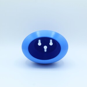 May include: A light blue oval-shaped planter with three holes in the bottom for drainage.