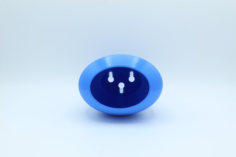 May include: A light blue oval-shaped planter with three holes in the bottom for drainage.