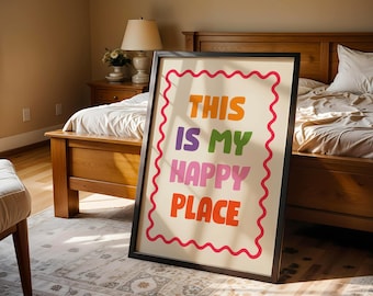 May include: A rectangular framed wall art piece with a cream background and a red wavy border. The text reads THIS IS MY HAPPY PLACE in stacked, multi-colored block letters including orange, purple, green, pink, and red.