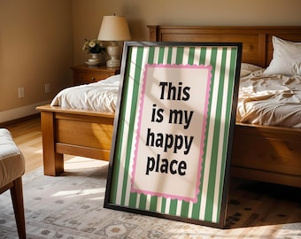 May include: A rectangular framed wall art piece featuring a vertical green and white striped background. In the center, a cream-colored rectangular panel with a scalloped pink border displays the black text: This is my happy place.