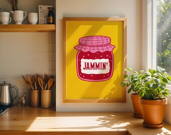 May include: A framed wall art print featuring a bright yellow background with a central illustration of a red jam jar. The jar has a pink checkered lid and a white label with the text JAMMIN' printed in bold red capital letters.