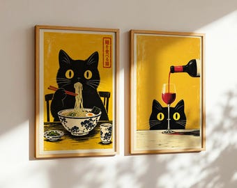 May include: Two framed wall art prints with yellow backgrounds featuring black cats. The left print shows a cat eating noodles with chopsticks and includes the Japanese text 麺を食べる猫. The right print shows a cat watching red wine being poured into a glass.