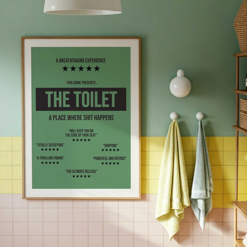 May include: A rectangular wall poster with a green background and black text. The poster reads A BREATHTAKING EXPERIENCE, THIS HOME PRESENTS THE TOILET, A PLACE WHERE SHIT HAPPENS, and includes five-star reviews with phrases like TOTALLY SATISFYING.
