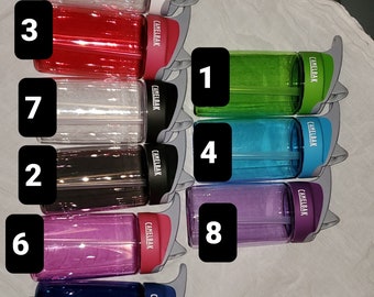 May include: Nine different colored 14 oz water bottles with a flip top lid. The bottles are lined up vertically and labeled with numbers 1 through 9.