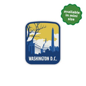 May include: A blue and yellow sticker featuring a silhouette of the Washington Monument, the Capitol Building, and a tree. The text "WASHINGTON D.C." is printed below the image.