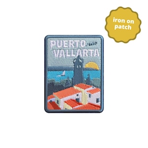 May include: Iron-on patch featuring a colourful embroidered scene of Puerto Vallarta, Mexico. The patch depicts a cityscape with buildings, a lighthouse, and a sailboat on the water. The text "PUERTO VALLARTA" is embroidered in white on a blue background.