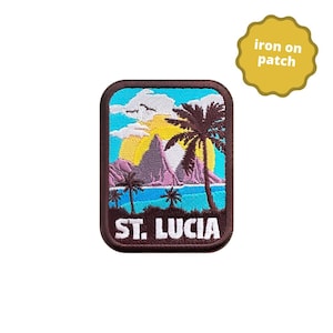 May include: An iron-on patch featuring a colourful embroidered scene of a tropical island with palm trees, a mountain, and a blue ocean. The text "ST. LUCIA" is embroidered in white on the patch.