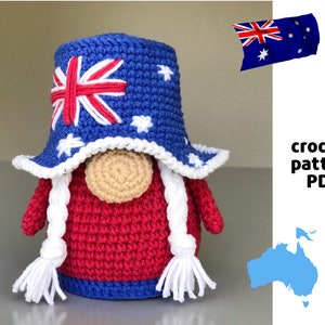 May include: Crocheted gnome wearing a blue and white hat with the Australian flag and stars. The gnome has a red body and white braids. The text "crochet pattern PDF" is visible in the image.