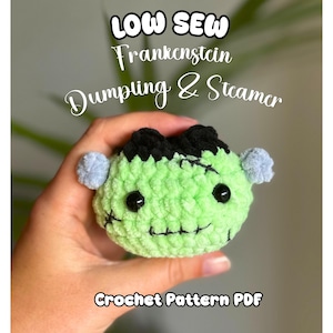 May include: A light green crochet plushie shaped like a Frankenstein monster head with black hair, black stitched details, and small light blue side bolts. The text reads LOW SEW Frankenstein Dumpling & Steamer Crochet Pattern PDF.