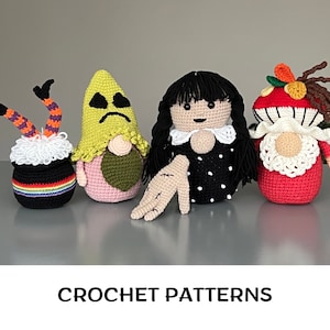 May include: Four crocheted gnomes, each with a unique design. One gnome is wearing a black and white polka dot dress, another is wearing a red dress with white trim, another is wearing a yellow hat with a sad face, and the last gnome is wearing a black cauldron with rainbow stripes.