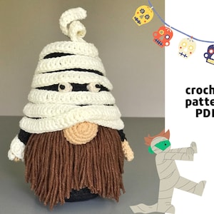 May include: Crochet pattern PDF for a mummy gnome with a brown beard and white crocheted bandages. The pattern includes a small illustration of a mummy figure.