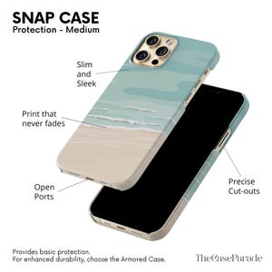 Może przedstawiać: Etui zatrzaskowe na telefon z motywem plażowym. Etui posiada jasnoniebieskie niebo i wz&oacute;r oceanu z piaszczystą plażą na dole. Etui jest smukłe i eleganckie z otwartymi portami i precyzyjnymi wycięciami.