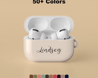 May include: A beige protective case for wireless earbuds with the name Lindsey printed in black script on the front. The case is open, revealing two white earbuds inside. Above the case, the text 50+ Colors is displayed in black.