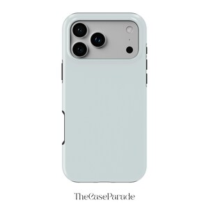 May include: A light blue smartphone case with a rectangular camera cutout featuring three circular lenses and a flash. The case has a smooth, solid-coloured back panel and black side buttons. The text TheCaseParade is printed below the device.