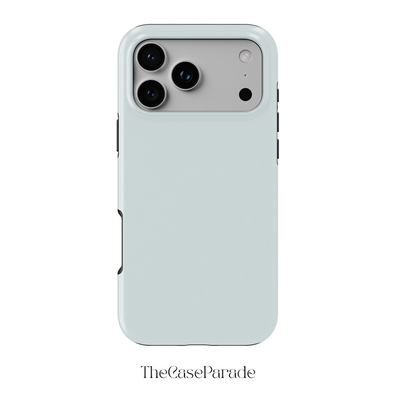 May include: A light blue smartphone case with a rectangular camera cutout featuring three circular lenses and a flash. The case has a smooth, solid-coloured back panel and black side buttons. The text TheCaseParade is printed below the device.