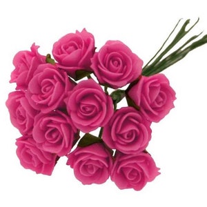 May include: A bouquet of 12 small pink artificial roses with green stems.