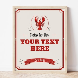 Könnte beinhalten: Ein gerahmter Druck mit hellbeigem Hintergrund und rotem Rand. Der Druck zeigt eine rote Hummerillustration über dem Text "Custom Text Here" und "YOUR TEXT HERE". Unten steht auf einem Banner "Let's Boil!"
