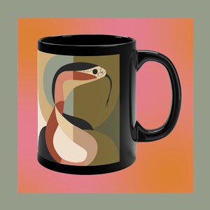 May include: Black coffee mug with a geometric design featuring a red, white, and black snake on a green and brown background.
