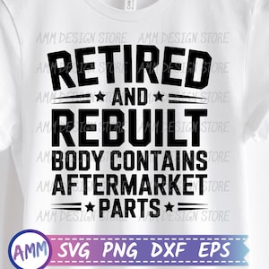 May include: White t-shirt with the text "RETIRED AND REBUILT BODY CONTAINS AFTERMARKET PARTS" in black. The shirt is hanging on a wooden hanger. The design includes stars and lines.