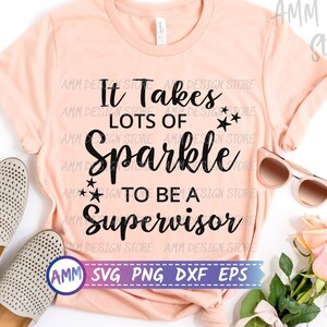 May include: A peach-coloured t-shirt with the text "It Takes Lots of Sparkle to Be a Supervisor" in black. The text is surrounded by small black stars.