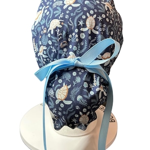Sea Turtle Ponytail Scrub Cap- cute women’s scrub hat with ribbon ties and optional satin lining in “Shell We Dance” fabric