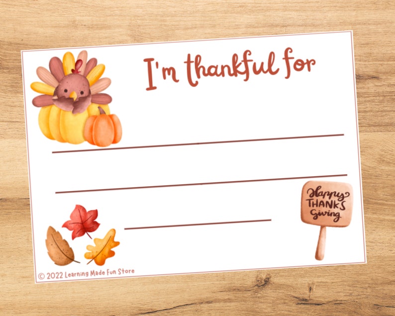May include: A printable Thanksgiving activity card featuring a cartoon turkey and pumpkin. The card has the text "I'm thankful for" and lines for writing. The card also includes a small sign that says "Happy Thanks Giving".