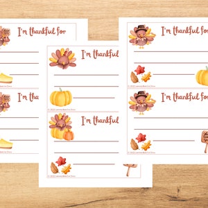 May include: Printable Thanksgiving activity cards featuring illustrations of turkeys, pumpkins, and pie. Each card has a line for writing "I'm thankful for..."
