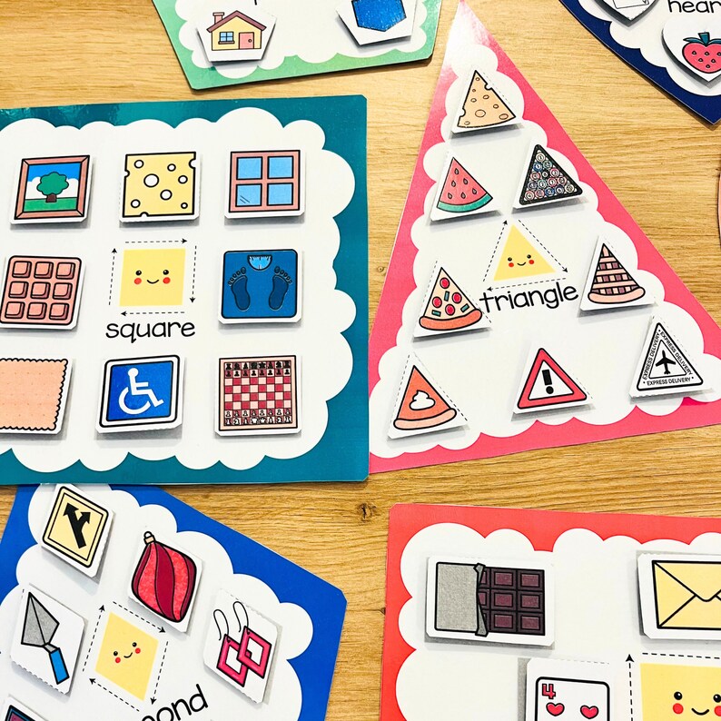 May include: A set of colorful educational flash cards with images and words for learning shapes. The cards feature a square, triangle, and other shapes with corresponding images.