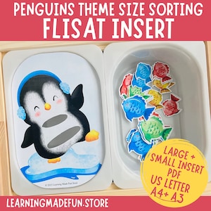May include: A penguin-themed size sorting activity for children. The activity includes a wooden tray with two compartments. One compartment has a penguin cutout with a space for inserting fish shapes. The other compartment has a variety of colorful fish shapes in two sizes. The text on the tray reads "PENGUINS THEME SIZE SORTING FLISAT INSERT" and "LARGE + SMALL INSERT PDF US LETTER A4+ A3".