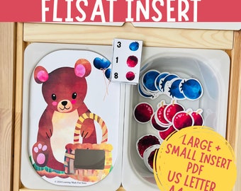 May include: A printable bear-themed counting activity for toddlers and preschoolers. The printable features a brown bear holding a basket with a space for counting fruit stickers. The printable includes a set of number cards with a visual representation of the numbers 1, 3, and 8. The printable is designed to be used with a FLISAT insert from IKEA. The printable is available in A4 and A3 sizes.