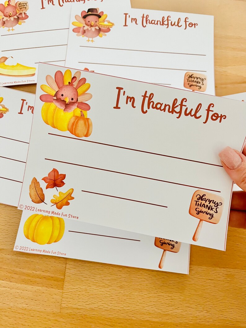 May include: Printable Thanksgiving activity cards featuring a cute cartoon turkey with the text "I'm thankful for" and lines for writing. The cards are decorated with autumn leaves and pumpkins.