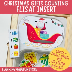 May include: A printable Christmas counting activity for a FLISAT insert. The activity features a red sleigh with Santa Claus and presents, along with a set of number cards and matching gift images. The text "Merry Christmas" is visible on the sleigh.