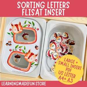 Peut inclure: Un ensemble imprimable de lettres majuscules et minuscules en forme de glands, conçu pour être utilisé avec un insert FLISAT. Les lettres sont imprimées sur un fond blanc avec un motif d'écureuil et de glands. L'ensemble comprend un fichier PDF aux formats A4 et A3.