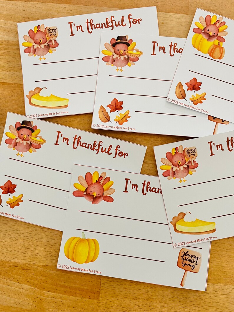 May include: Set of six printable Thanksgiving cards featuring a cartoon turkey with a pie, a pumpkin, and autumn leaves. Each card has a blank space for writing "I'm thankful for..." and a copyright notice at the bottom.
