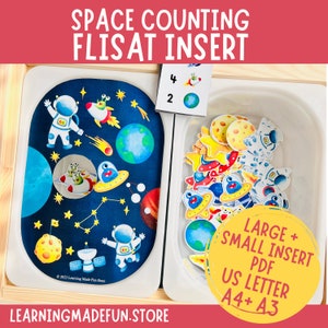 May include: A space-themed educational set with a dark blue mat featuring astronauts, planets, and rockets. Includes a card with numbers and space-themed images, plus cut-out space-themed shapes. The text on the image says "SPACE COUNTING FLISAT INSERT".