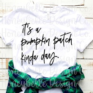 May include: White t-shirt with black text that reads "It's a pumpkin patch kinda day."