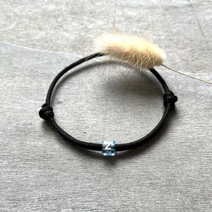 Pulseira Tau com letra azul água