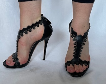 Alexander McQueen High Heel Shoes. Black Leather with Scull Pattern. Used but in Good Condition. Plastic Skeleton Earrings for Free.