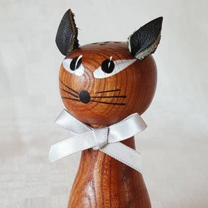 Vintage salt shaker made of teak and looking as a cat. With ears of leather and a hand painted face. Probably made in Denmark in the 1960's.